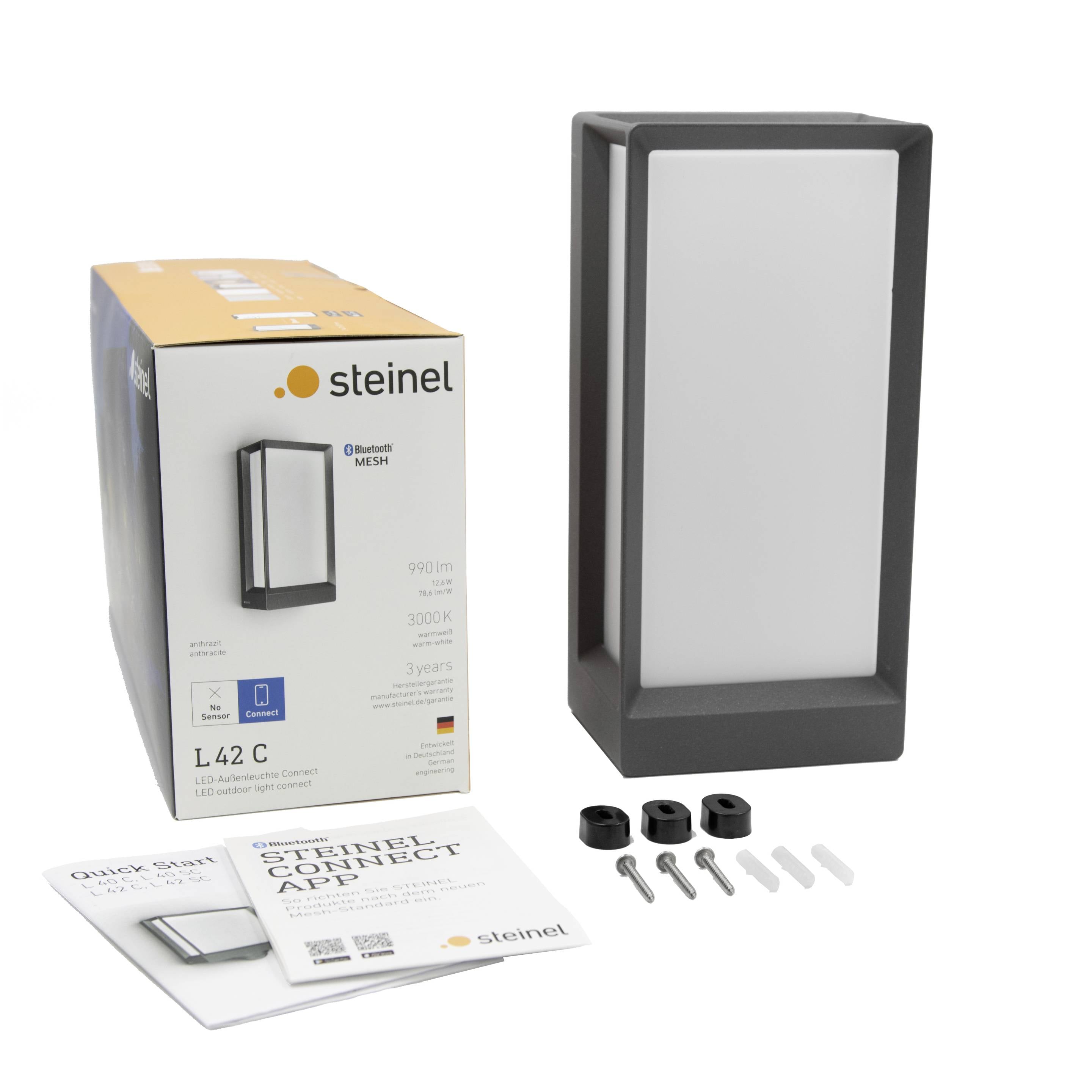 Eine Verpackung und eine schwarze LED-Wandlampe mit Zubehör. Auf der Verpackung ist der Markenname und Modell 'L42 C' sichtbar.