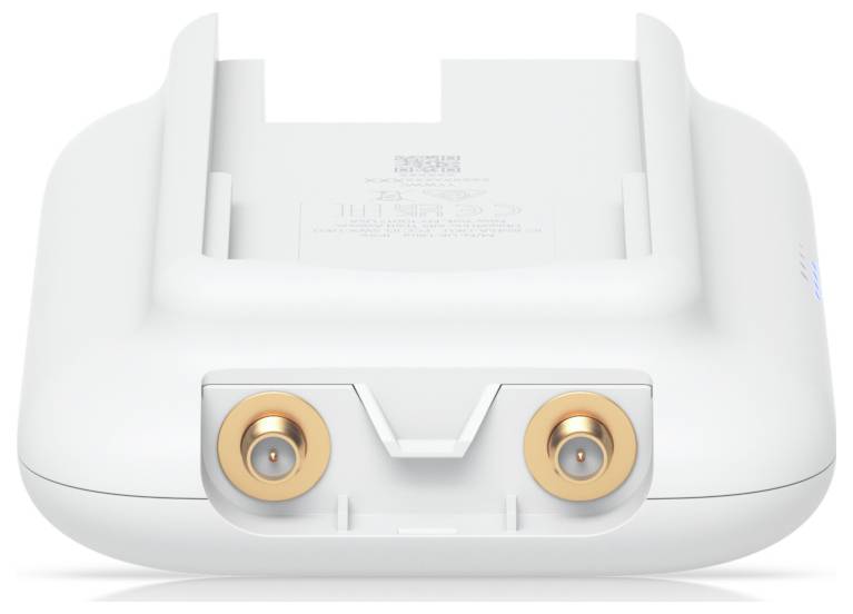 Ein weißes elektronisches Gerät mit zwei runden, goldfarbenen Anschlüssen auf der Vorderseite. Es scheint auf einer flachen Oberfläche zu liegen.