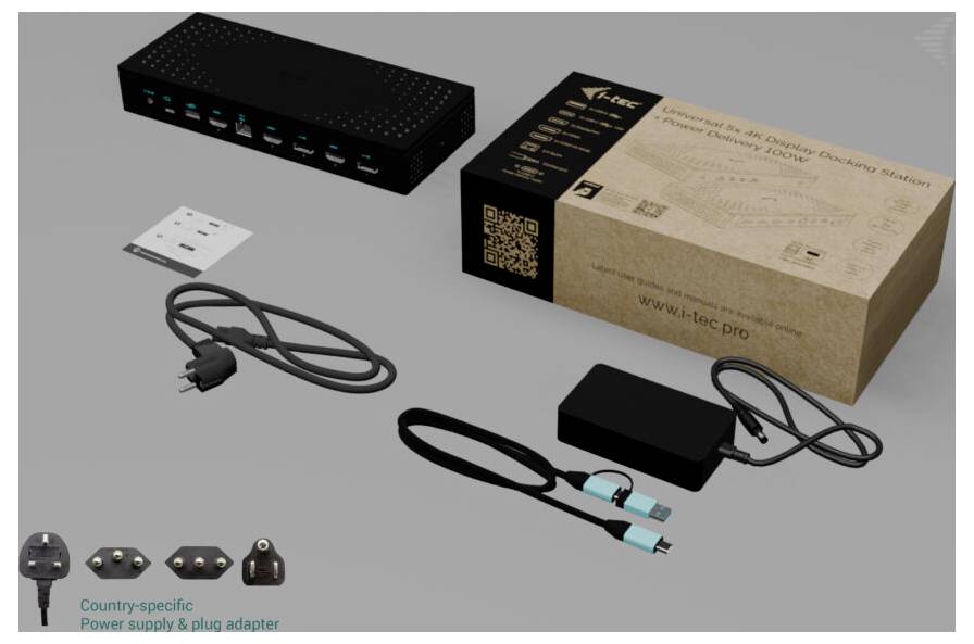 Eine schwarze Dockingstation mit mehreren USB-Anschlüssen liegt neben einem geöffneten Karton und verschiedenen Kabeln und Steckadaptern.
