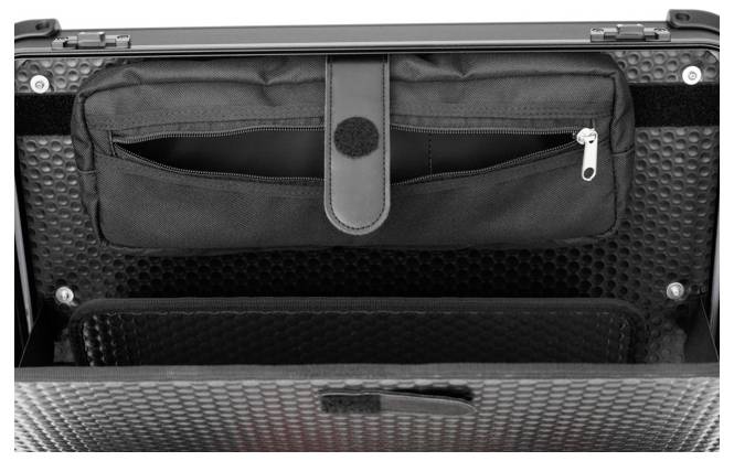 Ein offener, schwarzer Koffer mit Textur, zeigt eine Innentasche mit Reißverschluss. Der Innenraum ist leer und bereit für Gepäck.