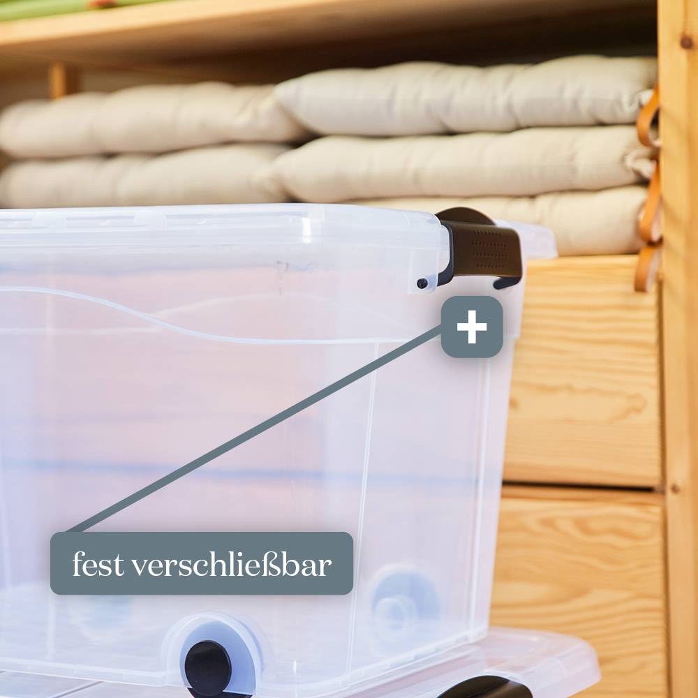 Eine Plastikkiste mit Deckel auf Rollen ist vor einem Holzschrank positioniert. Mit einem Etikett wird 'fest verschließbar' hervorgehoben.