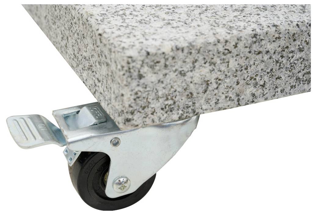 Ein Schwerlastrollenrad mit Bremse befindet sich unter einer grauen Granitplatte.