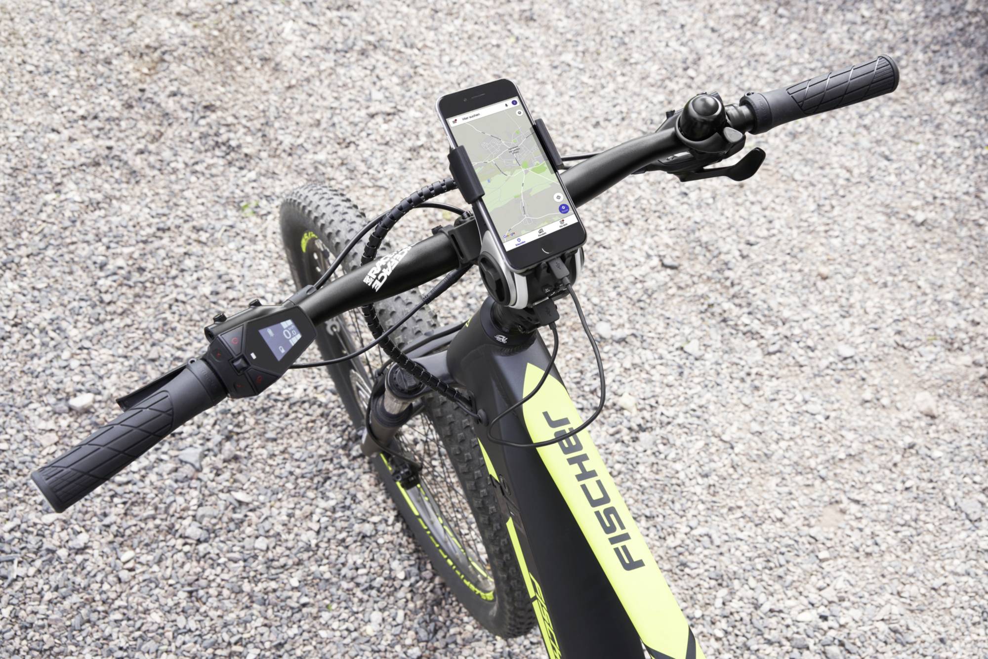 Ein Fahrradlenker eines E-Bikes der Marke Fischer. Auf dem Lenker ist ein Smartphone mit einer Karten-App befestigt.