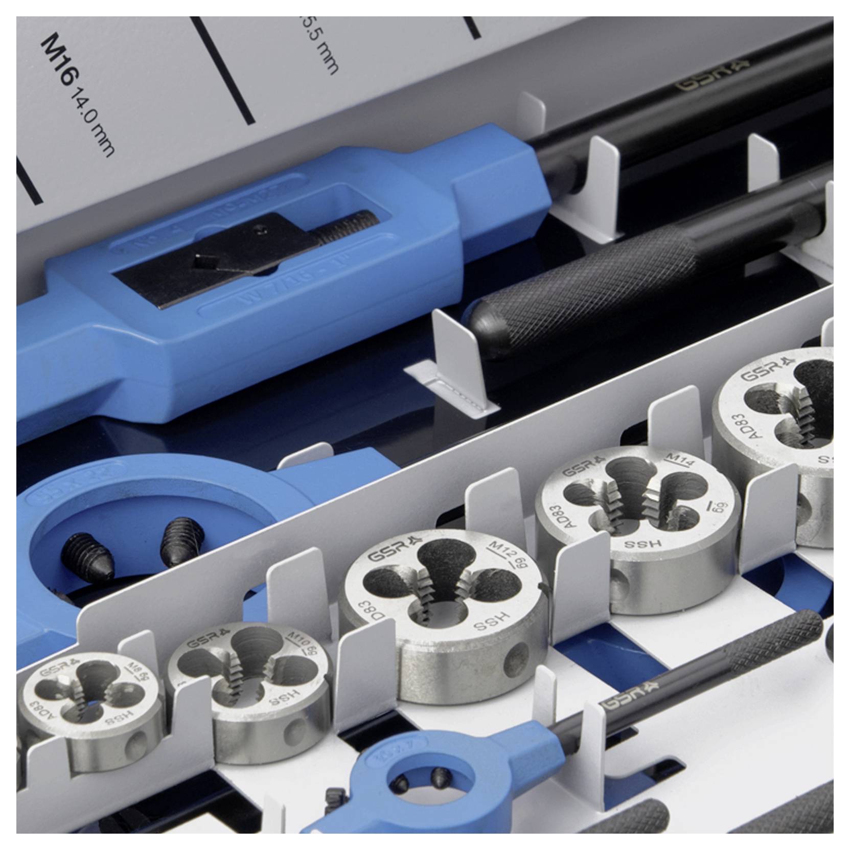 Ein Satz Gewindeschneider-Werkzeuge in einer offenen Box, mit mehreren Größen an Schneideisen und Werkzeugen, schematisch angeordnet.