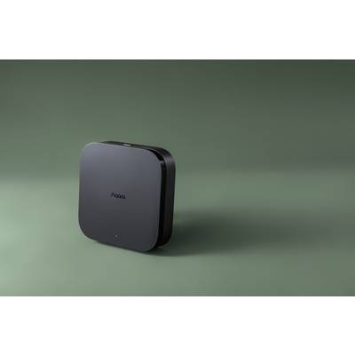 Ein quadratisches, schwarzes Gerät von 'Aqara' steht auf einem grünen Hintergrund, vermutlich ein Technologieprodukt.