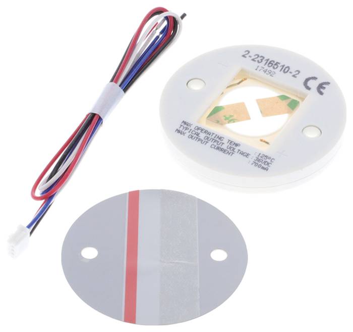 Ein kreisförmiges elektronisches Bauteil mit angebrachten Drähten, begleitet von einem runden Haftpad, was die Verwendung in der Elektromontage anzeigt.