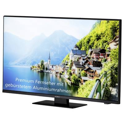 Ein Fernseher zeigt ein Bild von Hallstatt mit der Aufschrift 'Premium Fernseher mit gebürstetem Aluminiumrahmen!'