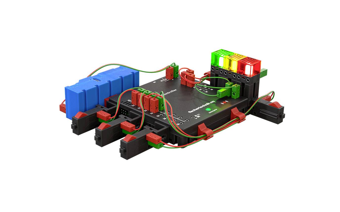 Ein elektronisches Schaltungsboard mit farbigen Komponenten, einschließlich blauer und roter Steckmodule sowie grüne und rote LEDs.