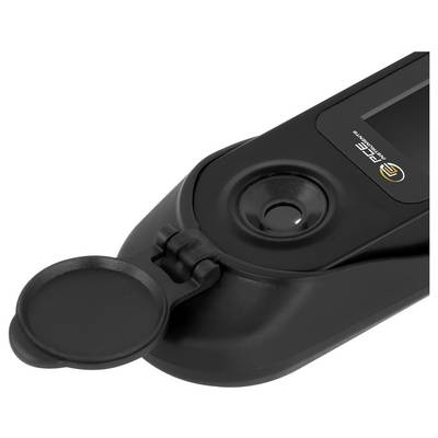 Nahaufnahme eines schwarzen tragbaren Geräts mit einer klappbaren runden Abdeckung über einem zentralen Sensor oder Knopf und einem kleinen Logo oben rechts.