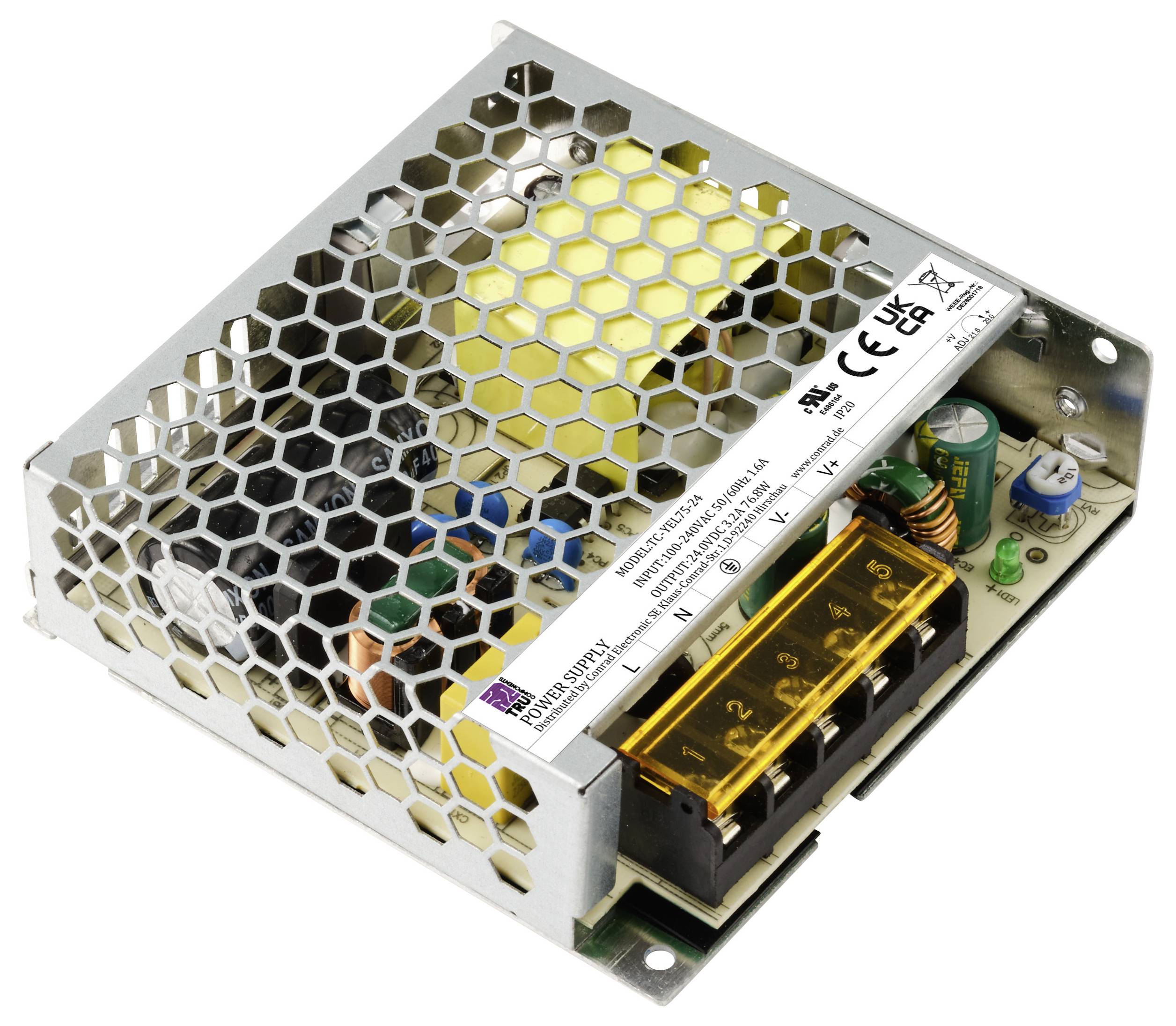 Ein offenes elektronisches Netzteil mit Wabenabdeckung, diversen Komponenten und einem gelben Aufkleber mit technischen Spezifikationen.