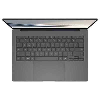Ein schwarzer Laptop ist von oben zu sehen. Die Tastatur hat ein deutsches QWERTZ-Layout. Auf dem Bildschirm ist verschwommener Text erkennbar.