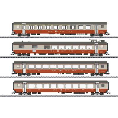 Vier verschiedene historische Eisenbahnwaggons in rot-grauer Farbe auf Gleisen, darunter ein Restaurantwagen.