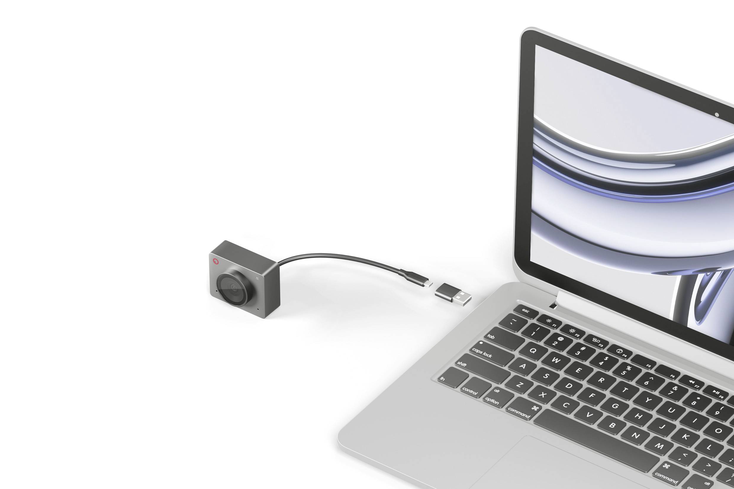 Eine Action-Kamera ist über ein USB-Kabel mit einem Laptop verbunden. Der Laptop zeigt ein stilisiertes, abstraktes Bild auf dem Bildschirm.