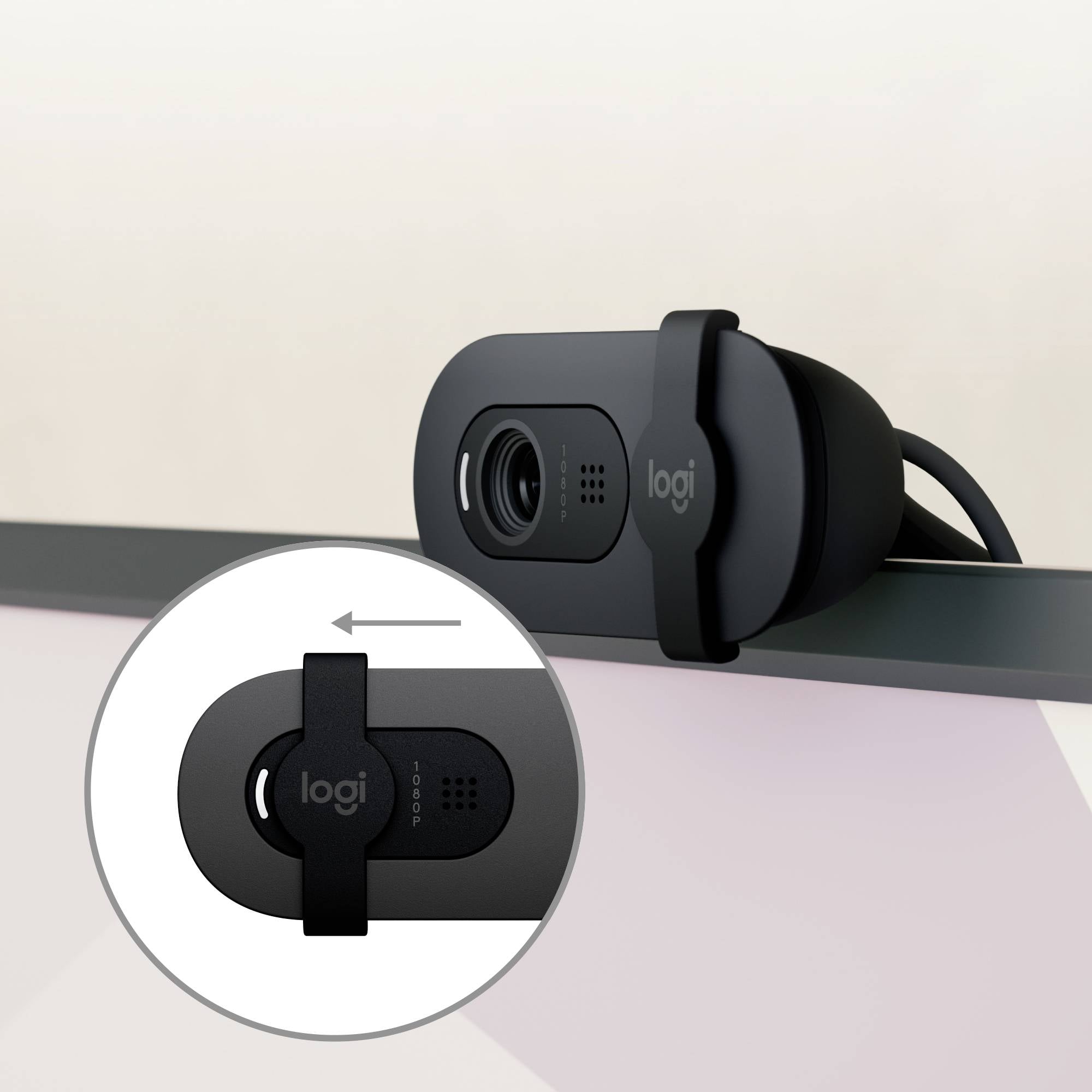 Eine schwarze Webcam mit einem Abdeckschieber, der die Linse verdeckt. Ein vergrößerter Einsatz zeigt den Schiebemechanismus.