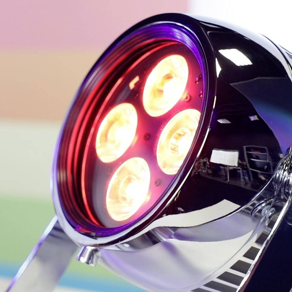 Runde Lampe mit vier leuchtenden LED-Lichtern, in einem modernen, glänzenden Gehäuse. Im Hintergrund sind verschwommene Farbbänder sichtbar.