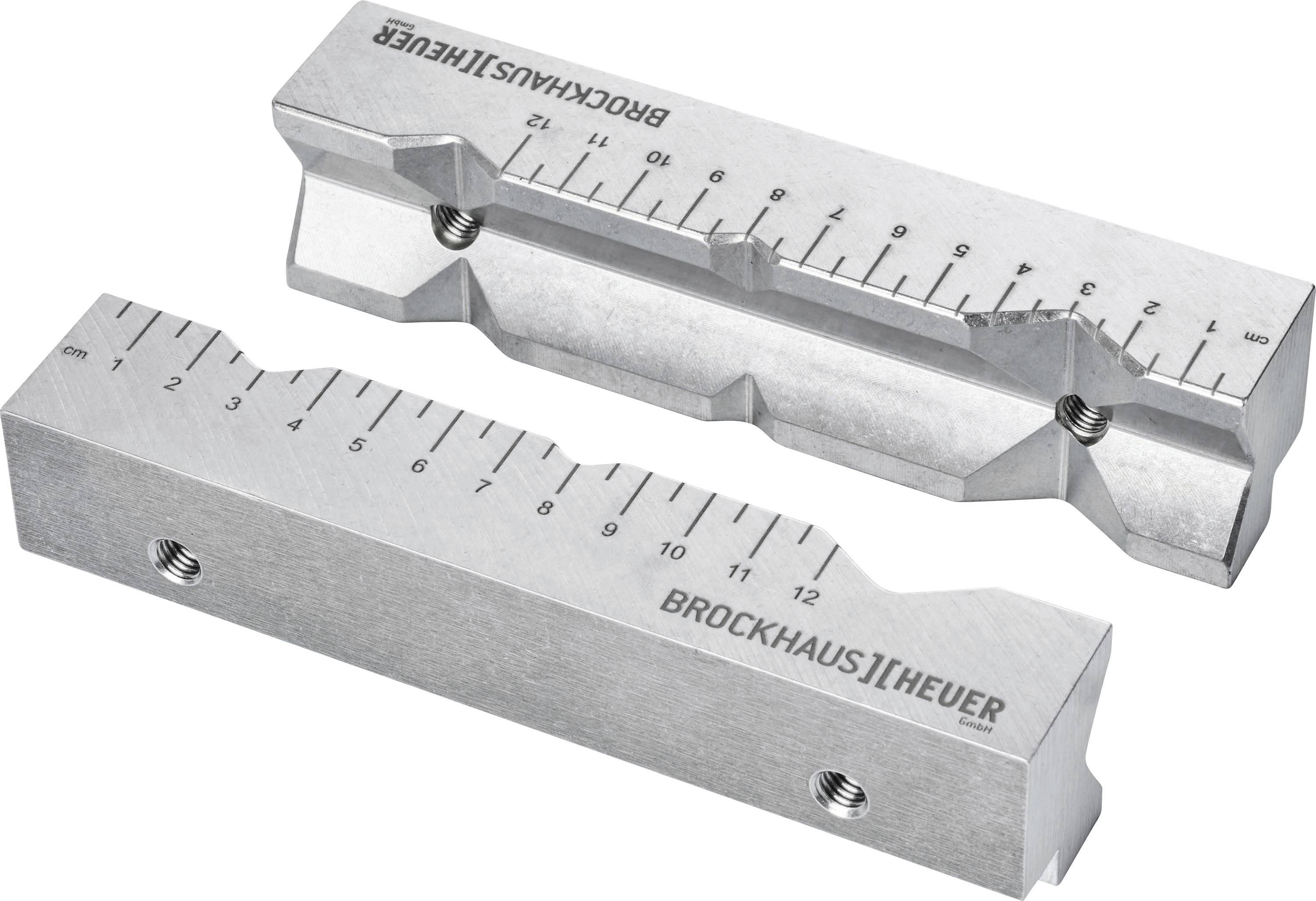 Spannbackenpaar aus Metall mit Messskala, geeignet für präzises Festspannen in Schraubstöcken. Markiert mit 'BROCKHAUS | HEUER'.