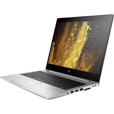 Silberner Laptop mit schwarzer Tastatur und Bildschirm, auf dem goldene Partikel auf schwarzem Hintergrund angezeigt werden.