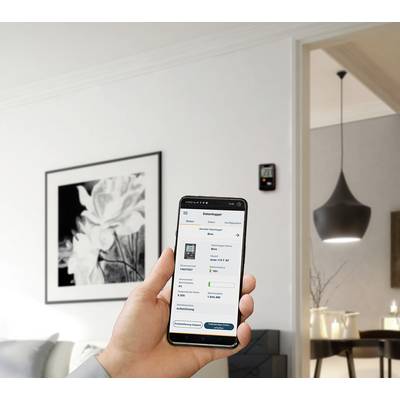 Eine Person hält ein Smartphone mit geöffneter Heizungssteuerungs-App; im Hintergrund modernes Wohnzimmer mit stilvoller Beleuchtung.