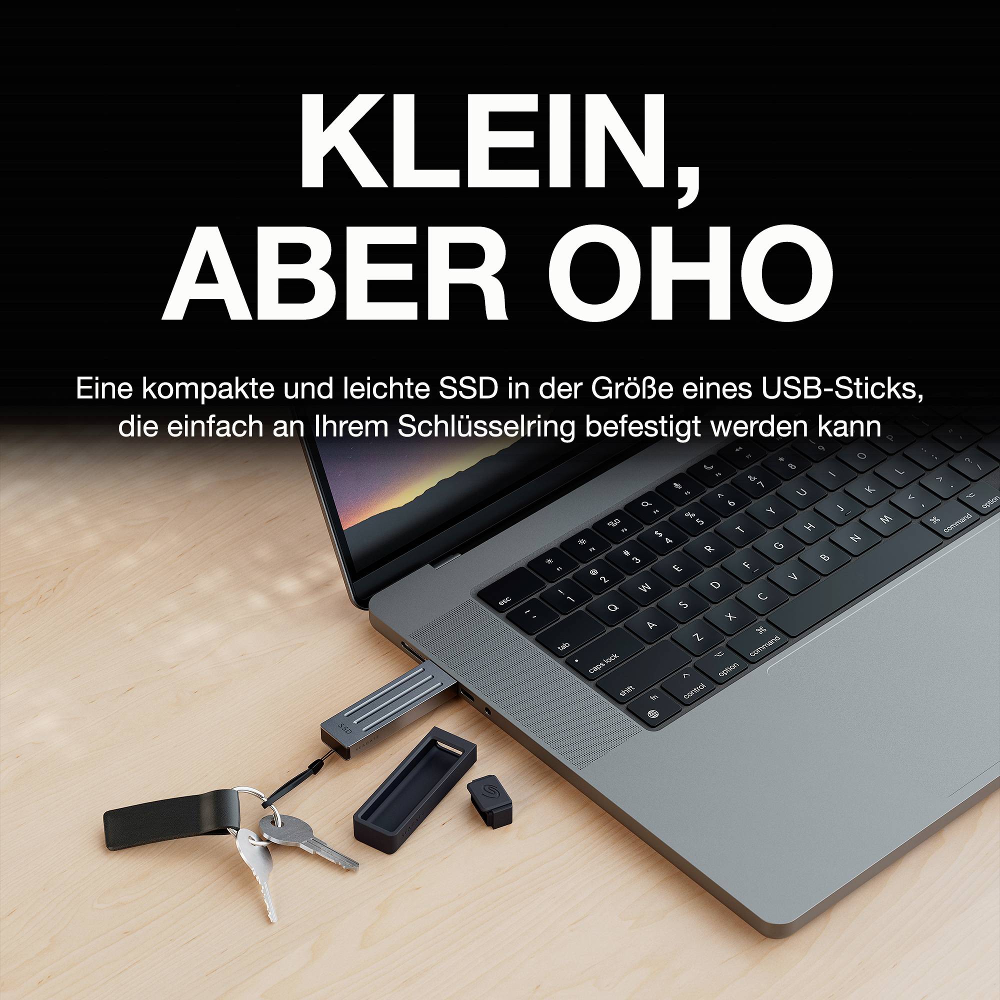 'Klein, aber oho' zeigt eine SSD in der Größe eines USB-Sticks neben einem Laptop auf einem Holztisch; Text mit Produktvorteilen.