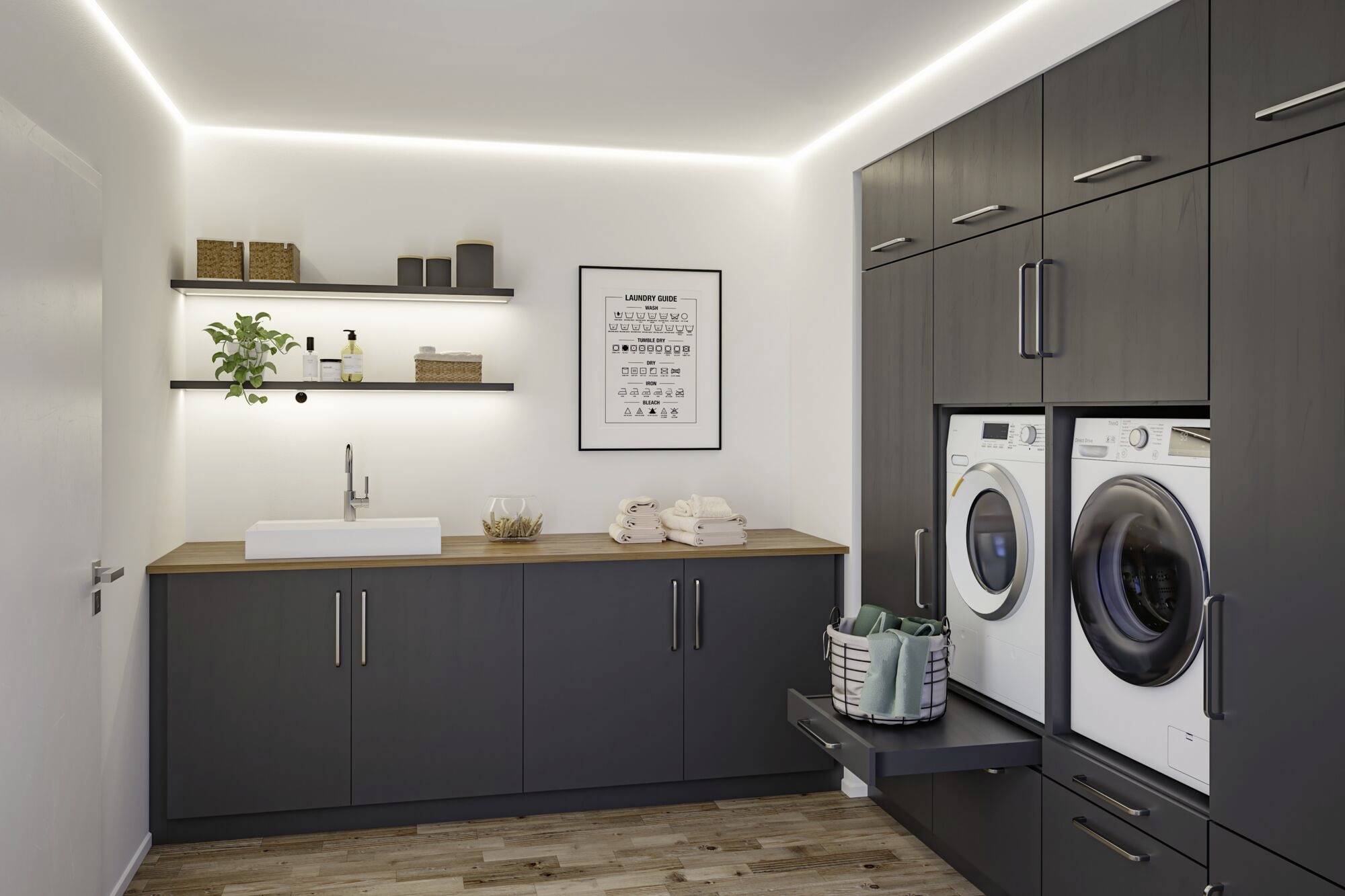 Moderner Hauswirtschaftsraum mit dunklen Schränken, Waschmaschine und Trockner. Ein Waschbecken ist in die Arbeitsfläche integriert.