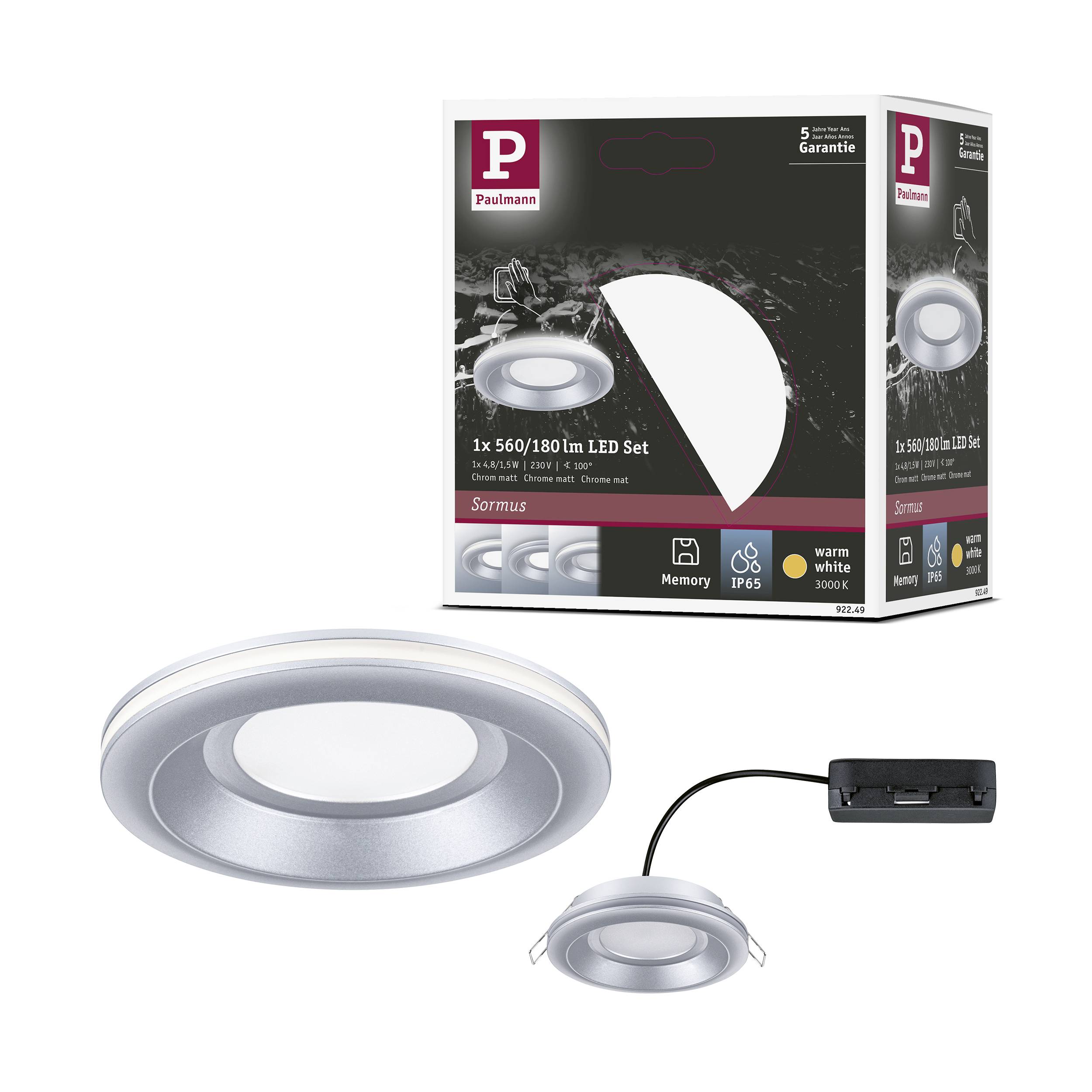 Ein rundes, silbernes LED-Lichtset mit Verpackung. '1x 560/180 lm LED Set' steht auf der Schachtel. Produkt zeigt warmweißes Licht.