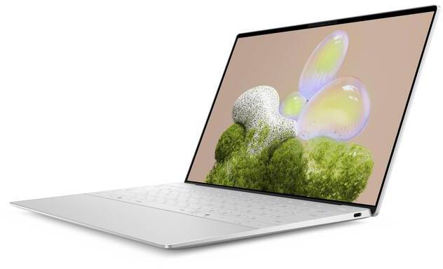 Ein silbernes Laptop mit offenem Display, das ein abstraktes Kunstwerk mit bunten Blasen und grünen Formen auf beigem Hintergrund zeigt.