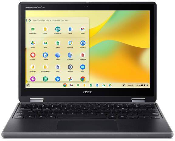 Ein Laptop mit einem geöffneten Display zeigt den Home-Bildschirm eines Betriebssystems mit mehreren App-Symbolen und einem Suchfeld.