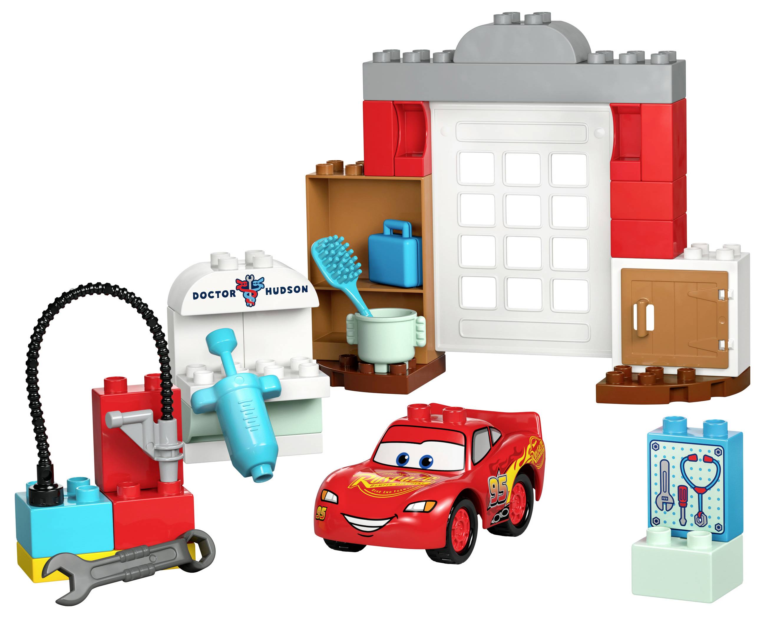 Spielzeug-Garage aus Bausteinen mit rotem Rennauto, Werkzeugen und Zubehör, inspiriert von einem Animationsfilm.