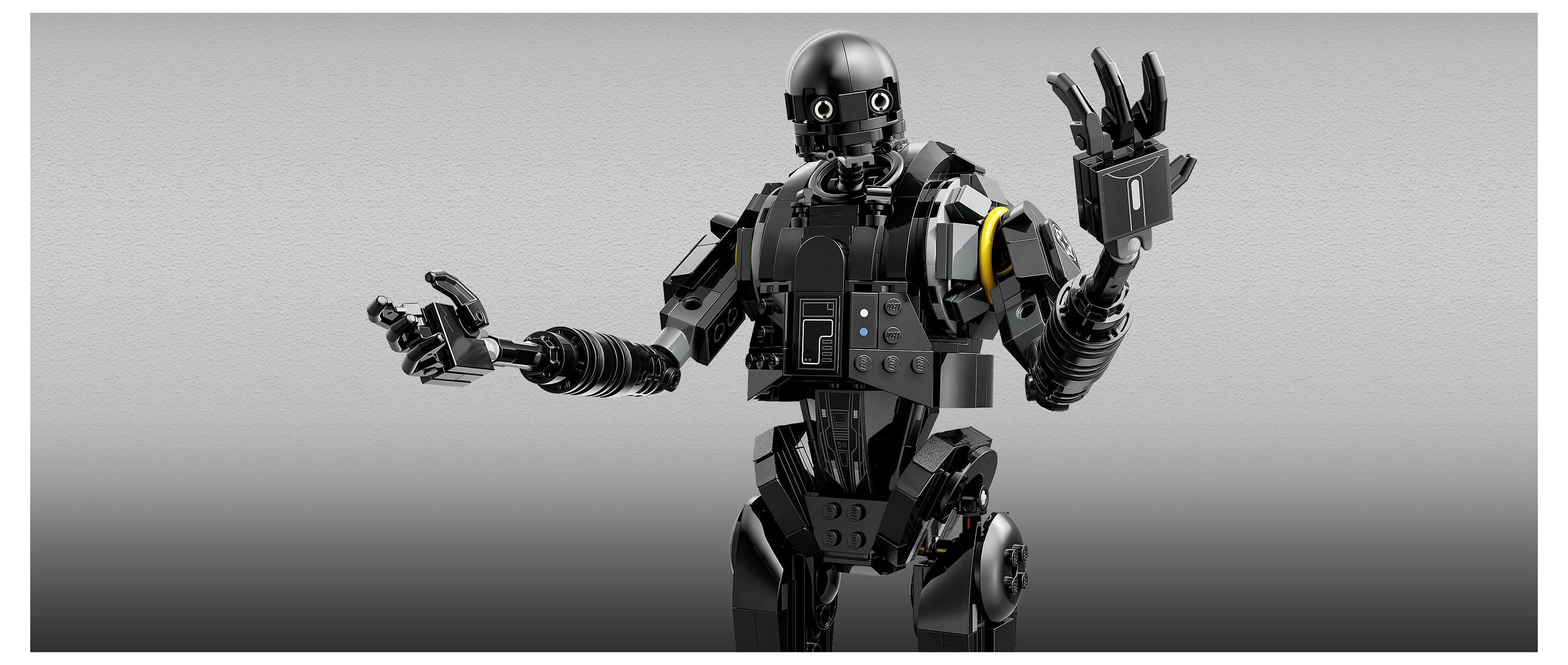 Ein schwarzer Roboter, gebaut aus Bausteinen, mit gelenkigen Gliedmaßen und beweglichen Fingern, steht vor einem neutralen Hintergrund und gestikuliert ausdrucksstark.