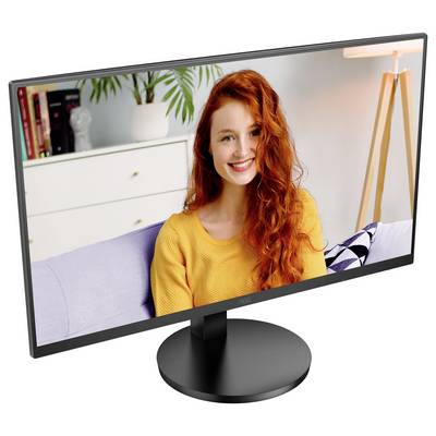 Ein Computermonitor zeigt eine lächelnde Person mit roten Haaren, die ein gelbes Oberteil trägt; im Hintergrund befinden sich Bücher und Pflanzen.
