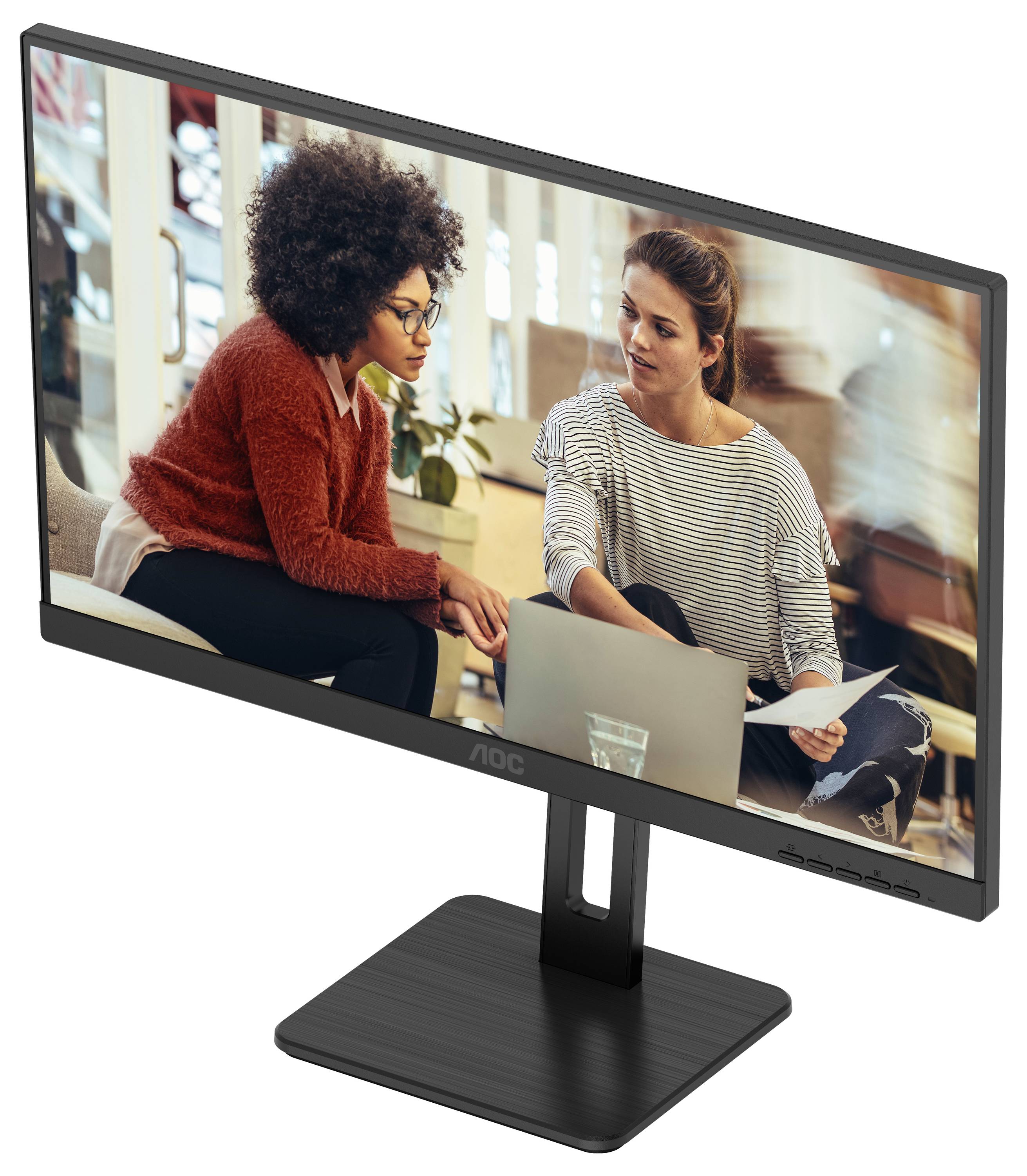 Zwei Frauen sitzen in einem modernen Büro und arbeiten gemeinsam an einem Laptop. Sie wirken konzentriert und diskutieren über ein Dokument.