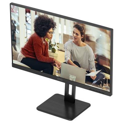 Zwei Frauen sitzen in einem modernen Büro und arbeiten gemeinsam an einem Laptop. Sie wirken konzentriert und diskutieren über ein Dokument.