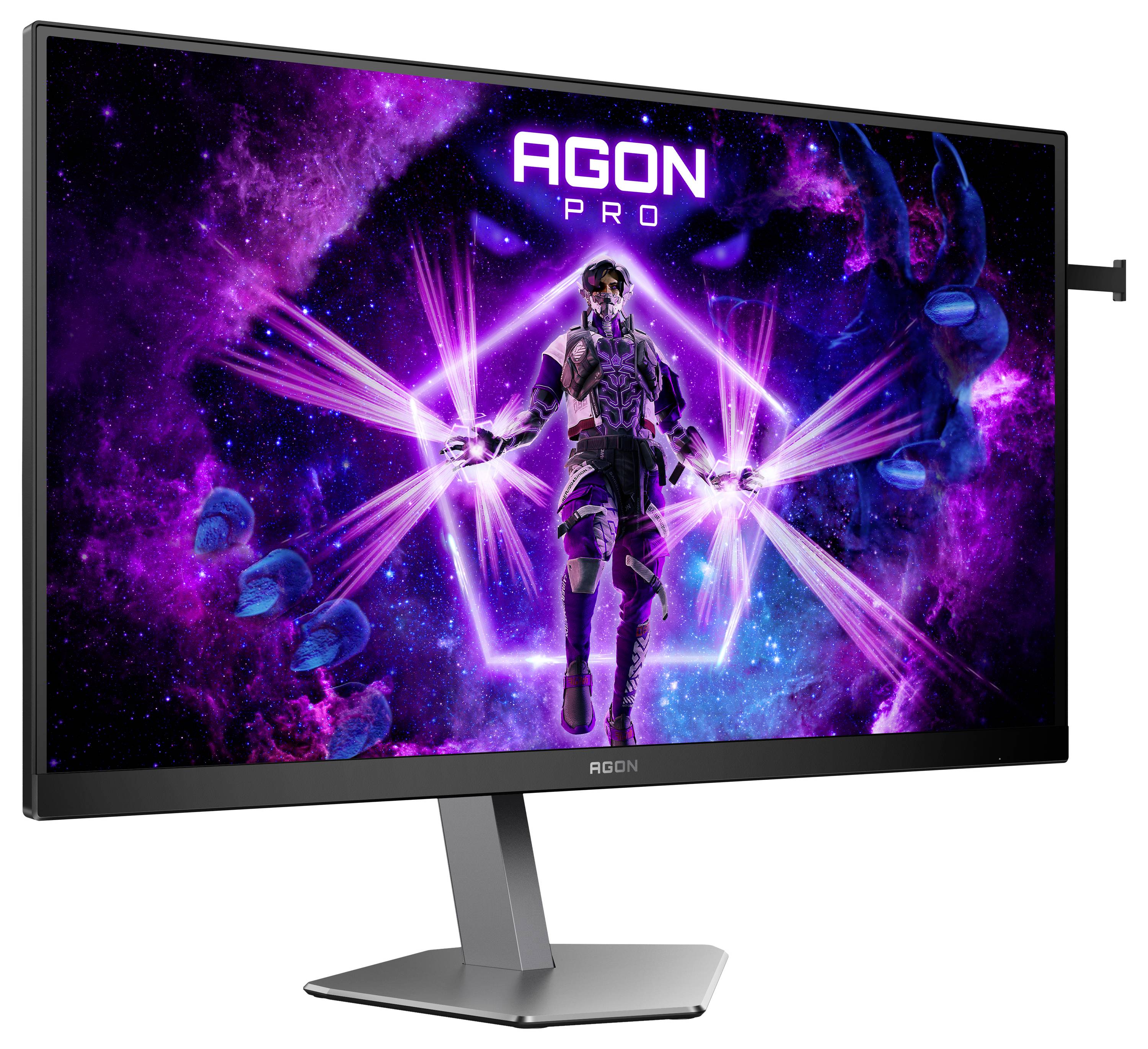 Ein Monitor zeigt eine futuristische Figur mit leuchtenden Effektlichtern auf einem violett-schwarzen Hintergrund, mit dem Text 'AGON PRO'.