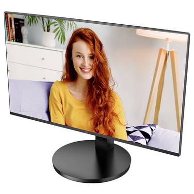 Frau mit langen roten Haaren und gelbem Pullover lächelt auf einem Monitorbildschirm. Im Hintergrund ein Bücherregal und Stehlampe.