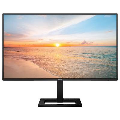 Ein Monitor zeigt ein Bild eines ruhigen Strandes bei Sonnenuntergang, mit orange-pinkem Himmel und ruhigem, blauem Meer.