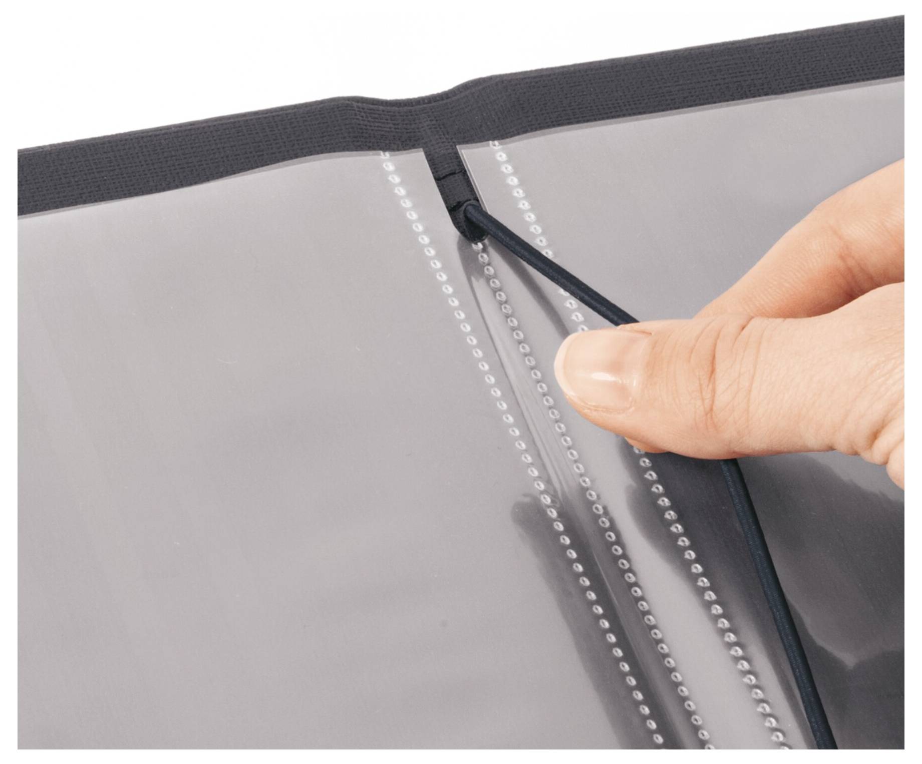 Hand sliding a zipper on a translucent document sleeve or binder divider.<br><br>---<br><br>Hand, die einen Reißverschluss auf einer durchscheinenden Dokumentenhülle oder einem Ordnertrenner zieht.