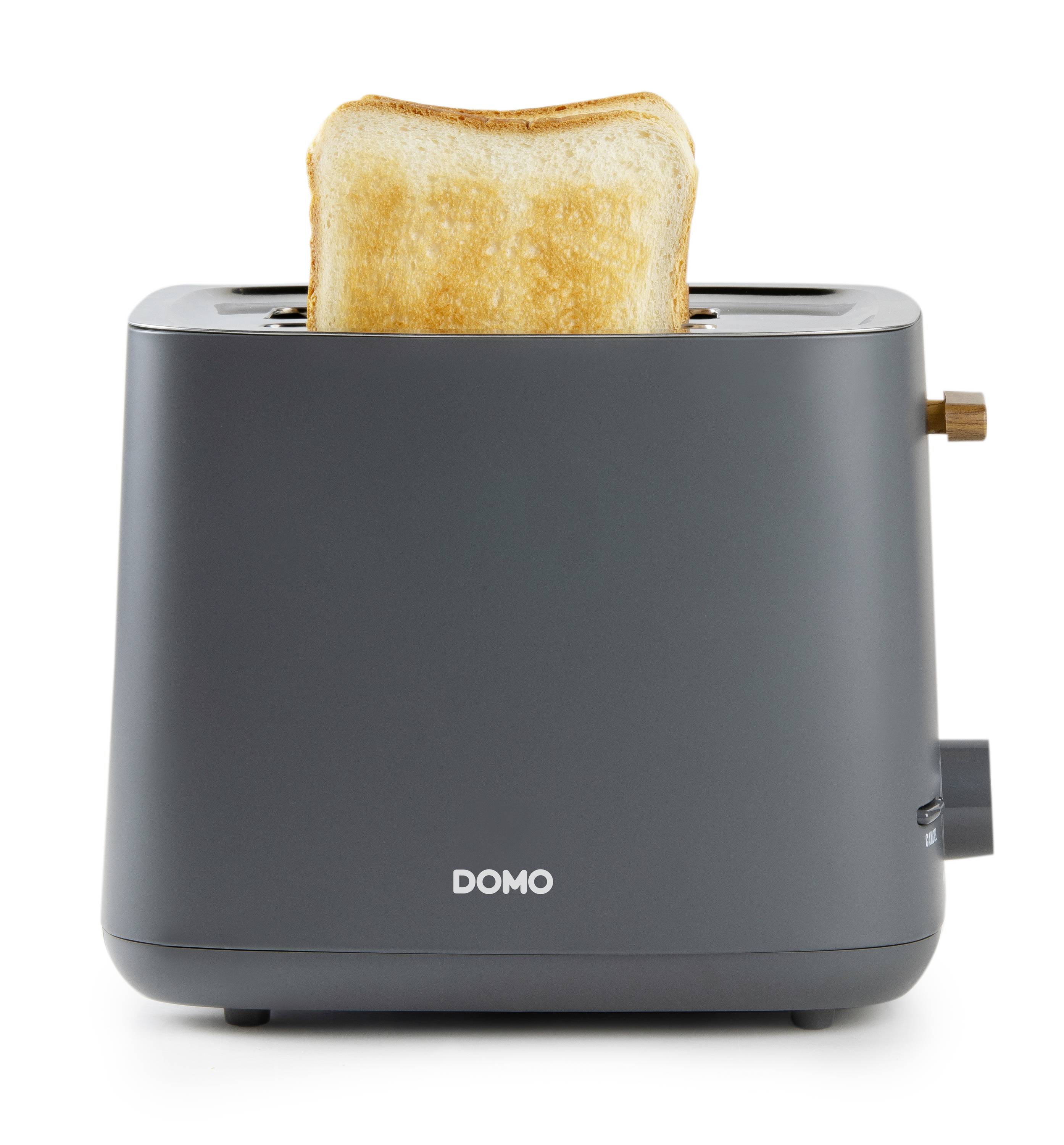 Ein schwarzer Toaster mit einem goldbraunen Toastscheibe oben. Der Toaster hat ein schlichtes Design und ein braunes Bedienelement.