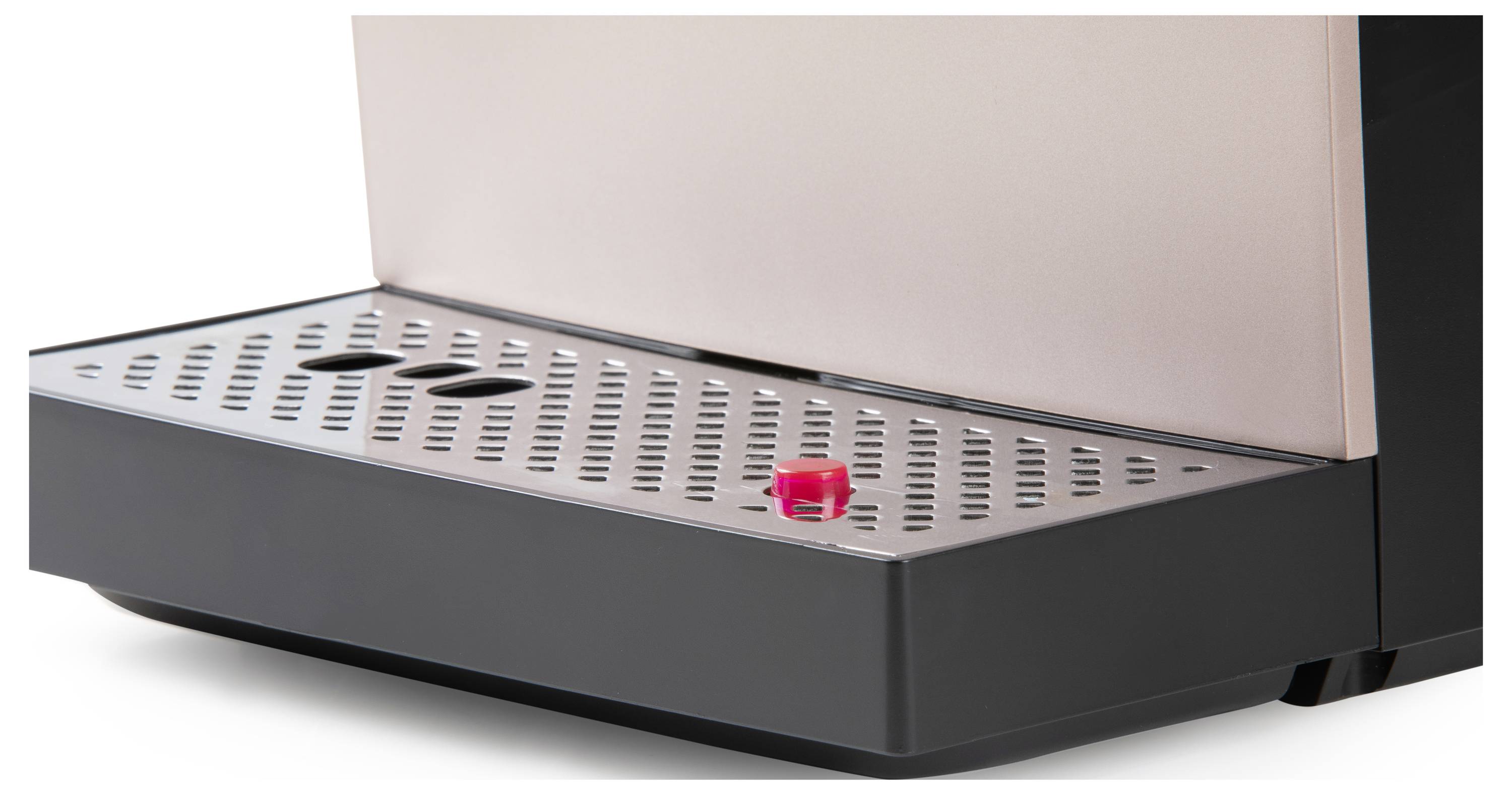 Eine Kaffeemaschine mit Tropfschale, darauf zwei schwarze Löcher und ein rotes Ventil sichtbar. Gerät minimalistisch gestaltet.