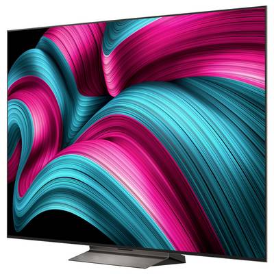 Ein großer, moderner Flachbildschirm-Fernseher, der ein lebendiges abstraktes Bild mit wirbelnden Wellen in Rosa und Petrol vor einem schwarzen Hintergrund zeigt.