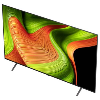 Ein moderner Flachbildschirm-Fernseher, der ein abstraktes Design mit wirbelnden grünen und orangefarbenen Mustern zeigt. Der Bildschirm wirkt scharf und farbenfroh.