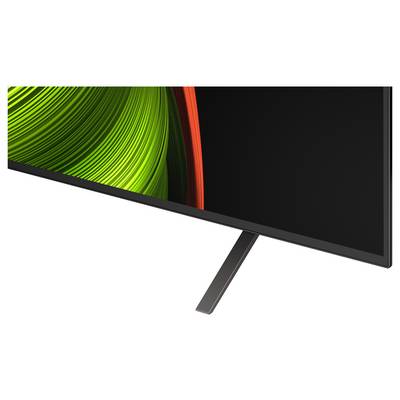 Ein schlanker, moderner Flachbildschirm-Fernseher mit schmaler Blende, der in einem Winkel gezeigt wird und ein leuchtendes grün-rotes abstraktes Design auf dem Bildschirm trägt.