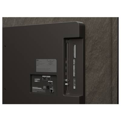Rückseite eines Fernsehers mit HDMI-Anschlüssen, USB-Buchse und Bedienungstasten auf einer dunklen Platte.