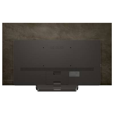Rückansicht eines dunkel gefärbten LG OLED-Fernsehers vor einer braunen strukturierten Wand, die Lüftungsschlitze und eine Halterung mit minimalistischem Design zeigt.