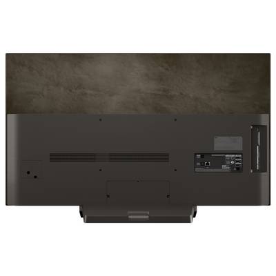 Rückansicht eines Flachbildschirm-Fernsehers, die verschiedene Anschlüsse und Verbindungen zeigt, einschließlich HDMI und USB. Wandmontage-Halterung sichtbar.