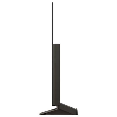 Seitenansicht eines schlanken Fernsehers auf einem Ständer, die dessen dünnes Profil und elegantes Design betont. Von diesem Winkel aus ist der Bildschirm kaum sichtbar.