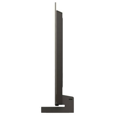 Seitenansicht eines dünnen, flachen Fernsehers auf einem Ständer, der sein schlankes Profil und minimalistisches Design hervorhebt.