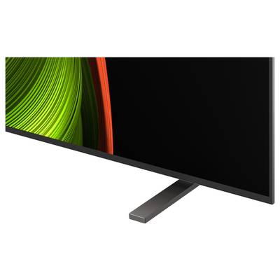 Ein moderner Flachbildschirm-Fernseher mit schmaler Einfassung, der auf einem Teil des Bildschirms lebendige grüne und rote abstrakte Grafiken zeigt.