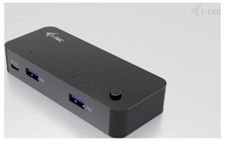 Schwarze USB-Dockingstation mit zwei USB-Anschlüssen und einem Knopf auf der Oberseite, seitlich ein DC-Anschluss. Marke 'i-tec'.