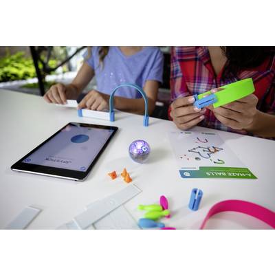 Zwei Personen bauen ein Experiment mit Technik und Spielzeug-Bauteilen. Ein Tablet zeigt eine App an. Kreatives Lernen und Technik.