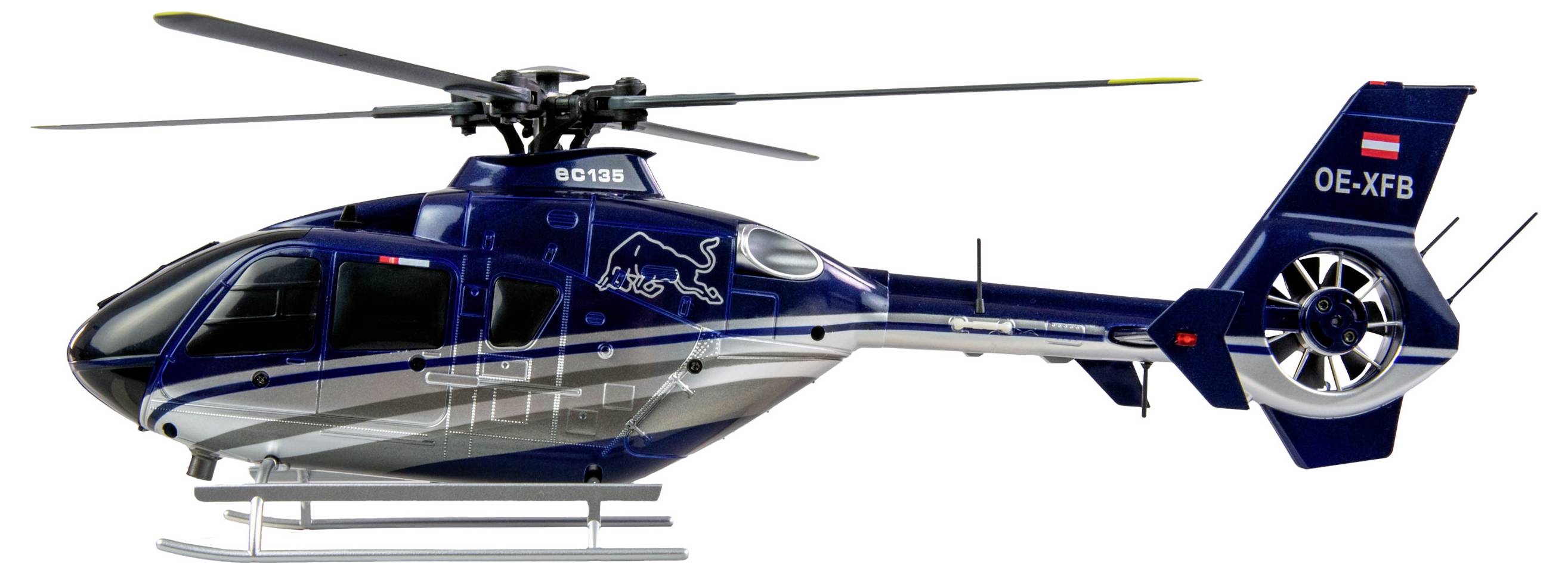 Ein blauer Helikopter mit einem Stier-Logo auf der Seite. Modellbezeichnung 'OE-XFB' am Heck erkennbar. Dreifarbige Lackierung.
